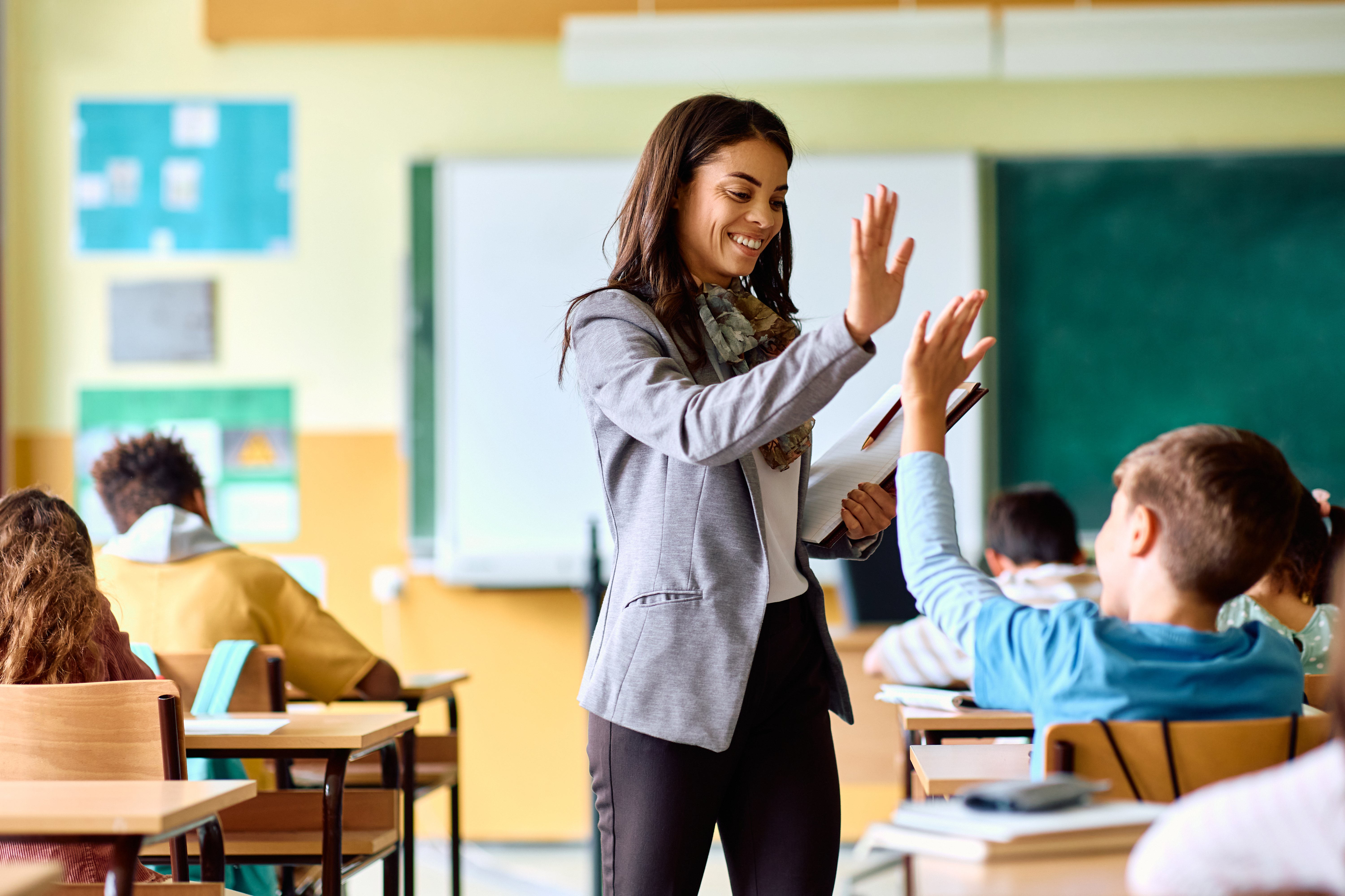 Teacher high-fiving a student.